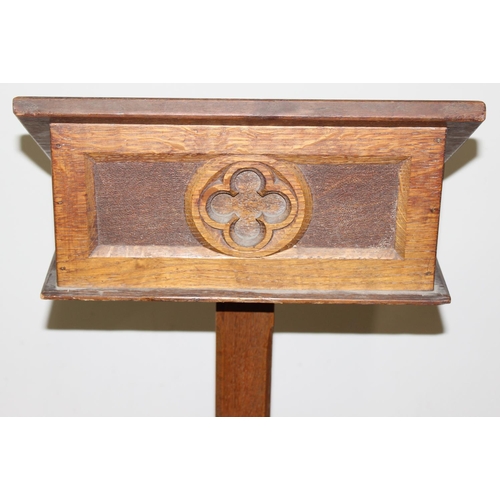 25 - A vintage oak lectern with carved details, approx 40cm wide x 40cm deep x 124cm tall