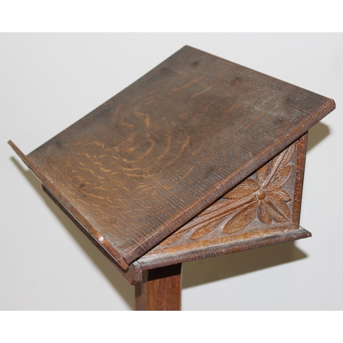 25 - A vintage oak lectern with carved details, approx 40cm wide x 40cm deep x 124cm tall
