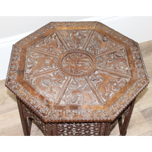36 - A South Asian carved hardwood folding octagonal topped table with folding wooden base, approx 61cm i... 