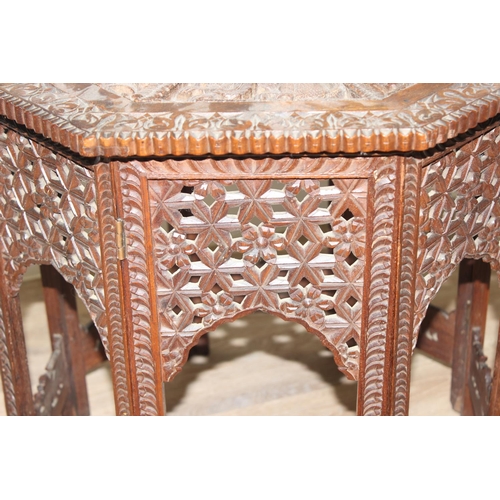 36 - A South Asian carved hardwood folding octagonal topped table with folding wooden base, approx 61cm i... 