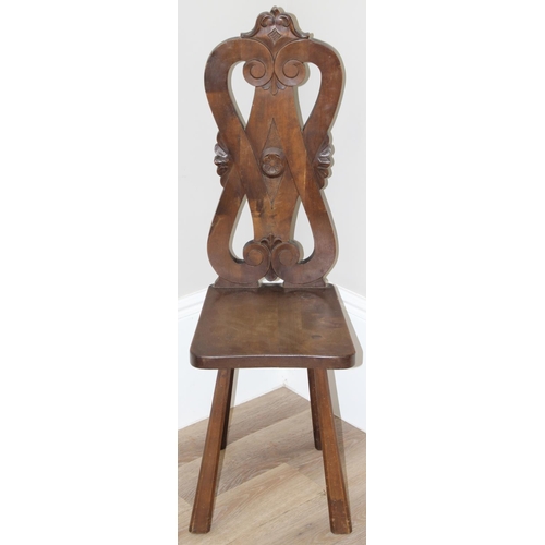 43 - A vintage wooden spinning chair with carved back, approx 107cm tall