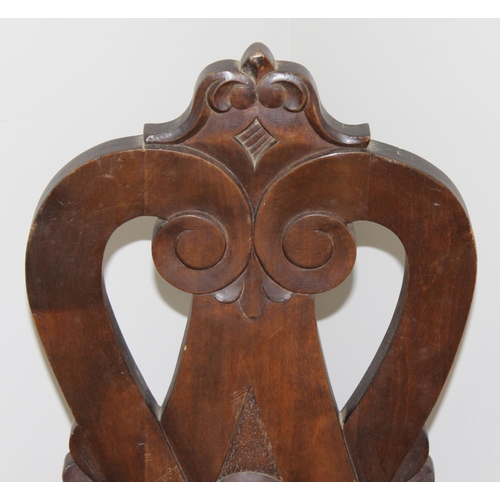 43 - A vintage wooden spinning chair with carved back, approx 107cm tall