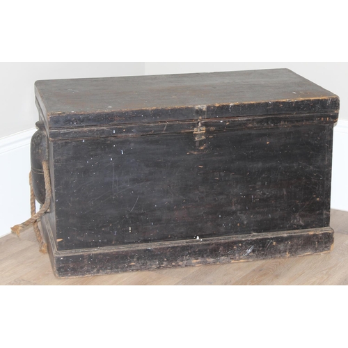 51 - A large antique black painted pine trunk, likely a naval tool box with rope handles, named to interi... 