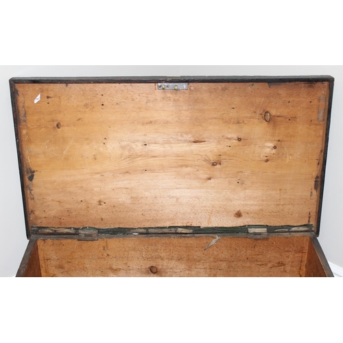 51 - A large antique black painted pine trunk, likely a naval tool box with rope handles, named to interi... 