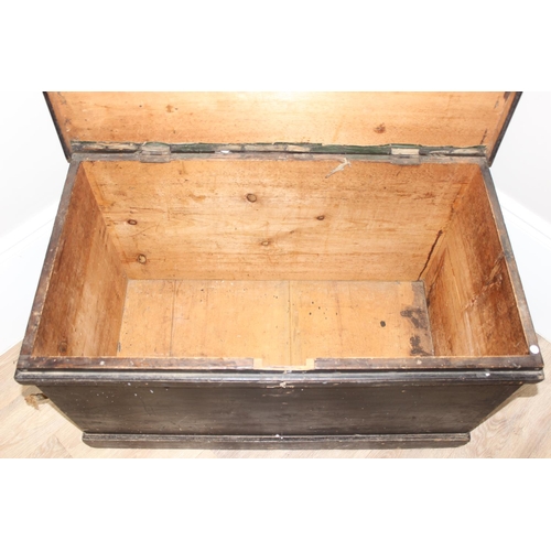 51 - A large antique black painted pine trunk, likely a naval tool box with rope handles, named to interi... 