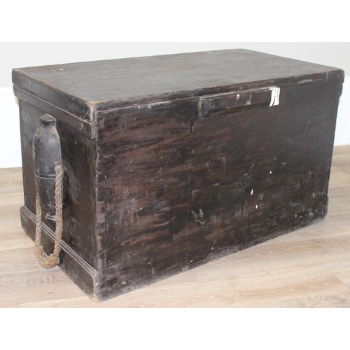 51 - A large antique black painted pine trunk, likely a naval tool box with rope handles, named to interi... 