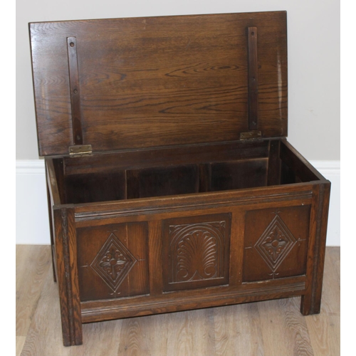 7 - An antique style oak coffer with carved detailing, approx 90cm wide x 46cm deep x 52cm tall