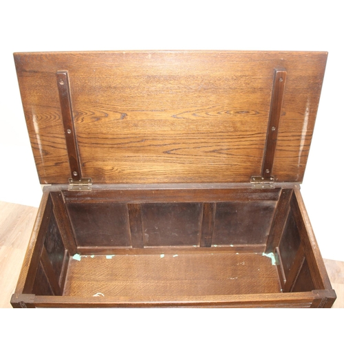 7 - An antique style oak coffer with carved detailing, approx 90cm wide x 46cm deep x 52cm tall