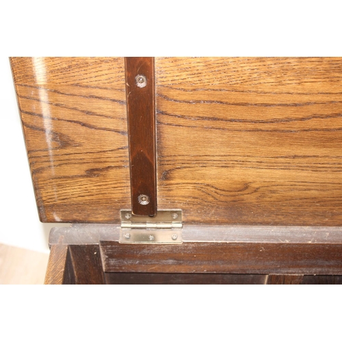 7 - An antique style oak coffer with carved detailing, approx 90cm wide x 46cm deep x 52cm tall