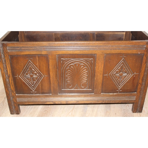 7 - An antique style oak coffer with carved detailing, approx 90cm wide x 46cm deep x 52cm tall