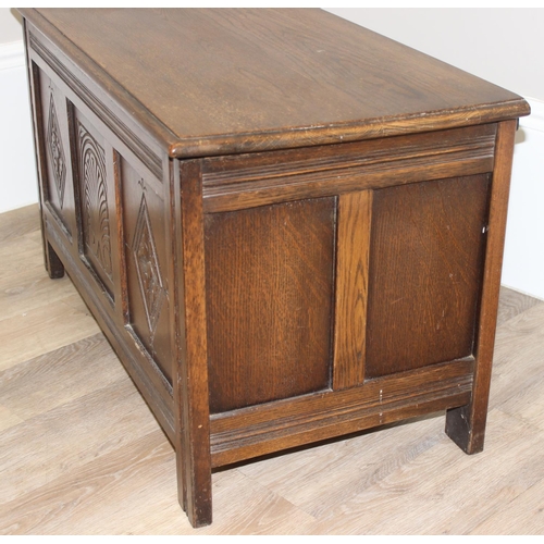 7 - An antique style oak coffer with carved detailing, approx 90cm wide x 46cm deep x 52cm tall