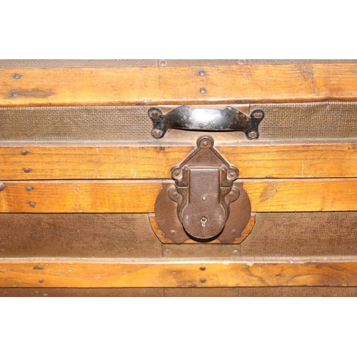 8 - An antique dome-topped chest or shipping trunk with wooden slats and iron fittings, approx 76cm wide... 