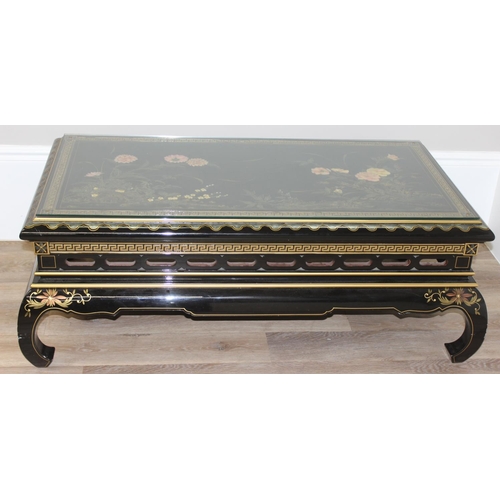 9 - An Oriental black lacquer and floral decorated coffee table, approx 123cm wide x 66cm deep x 47cm ta... 