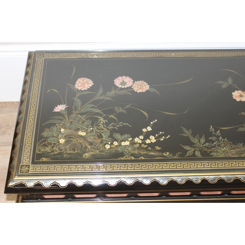 9 - An Oriental black lacquer and floral decorated coffee table, approx 123cm wide x 66cm deep x 47cm ta... 