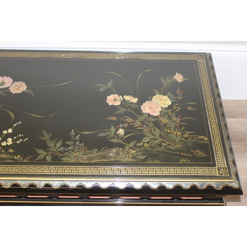 9 - An Oriental black lacquer and floral decorated coffee table, approx 123cm wide x 66cm deep x 47cm ta... 