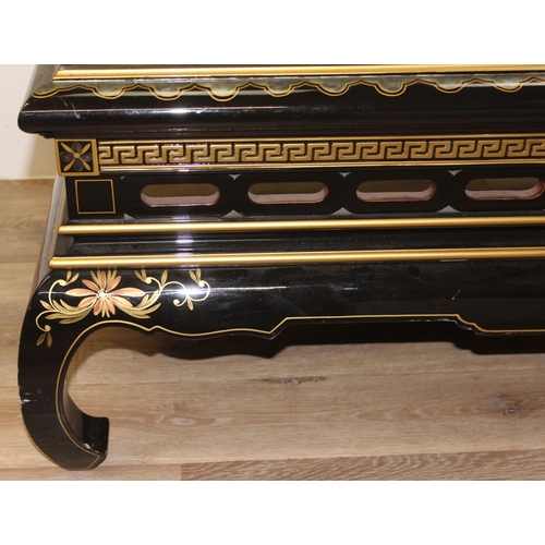 9 - An Oriental black lacquer and floral decorated coffee table, approx 123cm wide x 66cm deep x 47cm ta... 