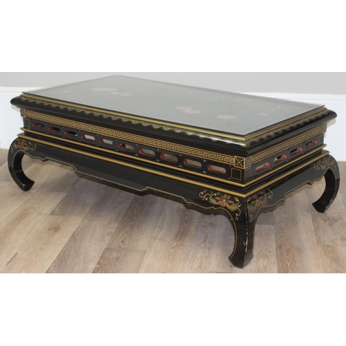 9 - An Oriental black lacquer and floral decorated coffee table, approx 123cm wide x 66cm deep x 47cm ta... 