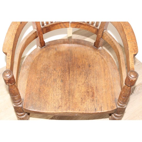 10 - An early 20th century oak armchair or desk chair on brass castors, approx 60cm wide x 55cm deep x 91... 