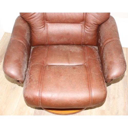 61 - A retro brown leather Ekornes style armchair and footstool, approx 75cm wide x 75cm deep x 110cm tal... 