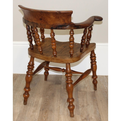 172 - An antique smokers bow or captain's chair, believed to be an elm seat and yew wood arms, with turned... 