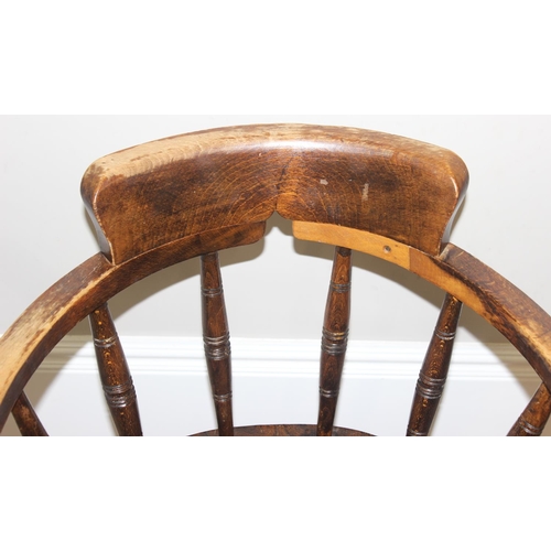 162 - An early 20th century smokers bow or captain's chair with elm seat, approx 79cm tall