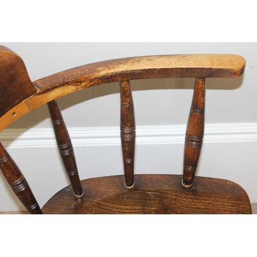 162 - An early 20th century smokers bow or captain's chair with elm seat, approx 79cm tall