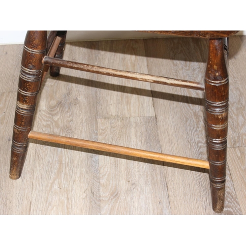 162 - An early 20th century smokers bow or captain's chair with elm seat, approx 79cm tall