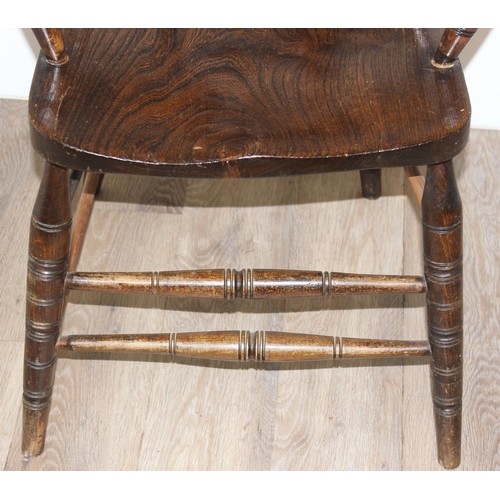 162 - An early 20th century smokers bow or captain's chair with elm seat, approx 79cm tall