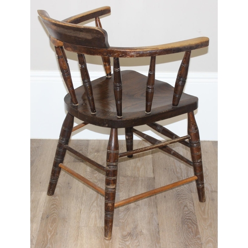 162 - An early 20th century smokers bow or captain's chair with elm seat, approx 79cm tall