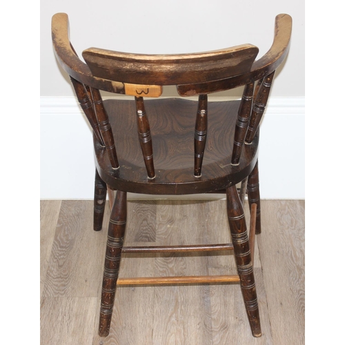 162 - An early 20th century smokers bow or captain's chair with elm seat, approx 79cm tall