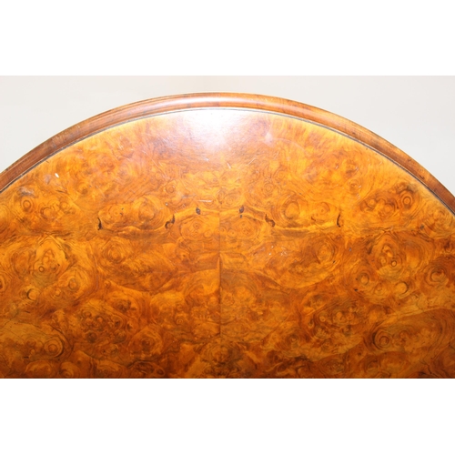 170 - A 19th century burr walnut tilt top oval breakfast table, the heavily carved base with 4 legs and ce... 