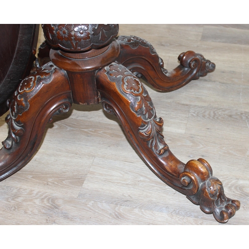 170 - A 19th century burr walnut tilt top oval breakfast table, the heavily carved base with 4 legs and ce... 