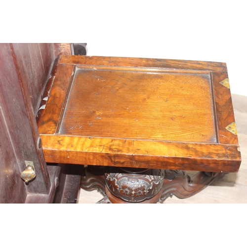 170 - A 19th century burr walnut tilt top oval breakfast table, the heavily carved base with 4 legs and ce... 