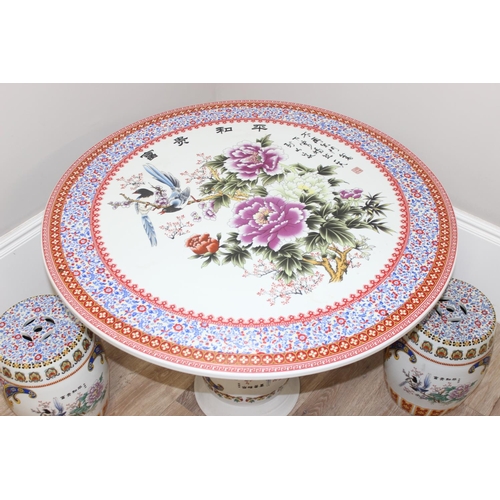 322 - Highly decorative Chinese porcelain garden table with Oriental design and 4 stools, table approx 93c... 