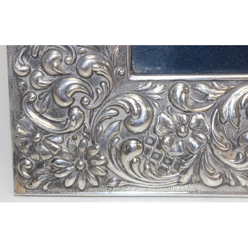 1001 - A large Sterling silver photograph frame decorated with embossed flowers and acanthus scrolls, Spani... 