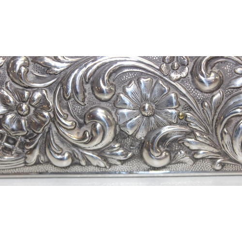 1001 - A large Sterling silver photograph frame decorated with embossed flowers and acanthus scrolls, Spani... 