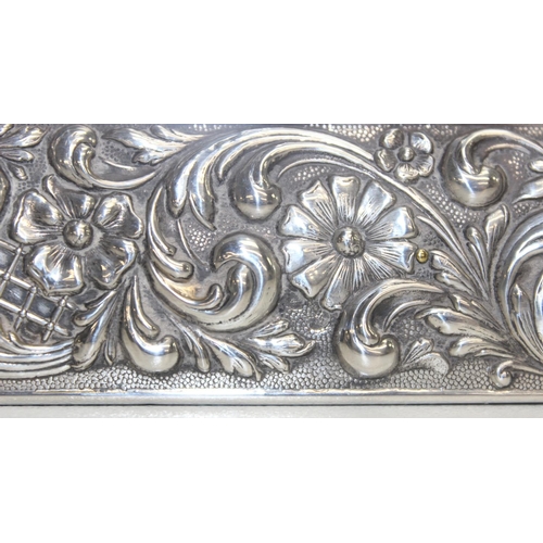 1001 - A large Sterling silver photograph frame decorated with embossed flowers and acanthus scrolls, Spani... 