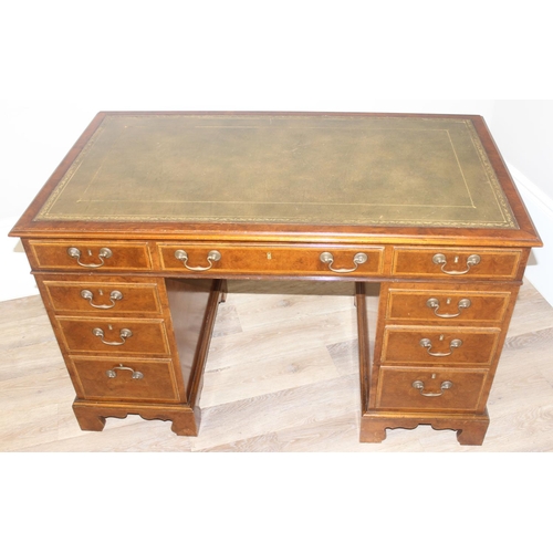 11 - A quality antique style pedestal desk with green inset gilt tooled leather top, walnut or yew wood w... 