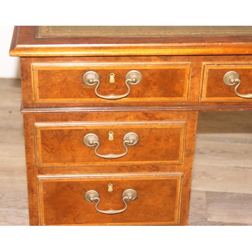 11 - A quality antique style pedestal desk with green inset gilt tooled leather top, walnut or yew wood w... 