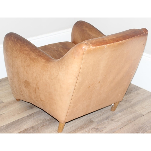 13 - A pair of Balzac club or armchairs in tan leather and a matching footstool, designed by Matthew Hilt... 