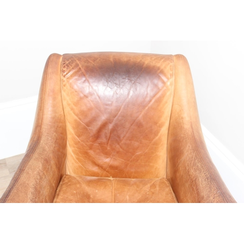 13 - A pair of Balzac club or armchairs in tan leather and a matching footstool, designed by Matthew Hilt... 