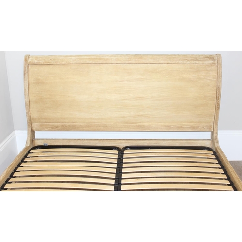 19 - A Loaf Furniture limed oak sleigh formed bed frame, to fit a super king mattress, approx 180cm x 200... 