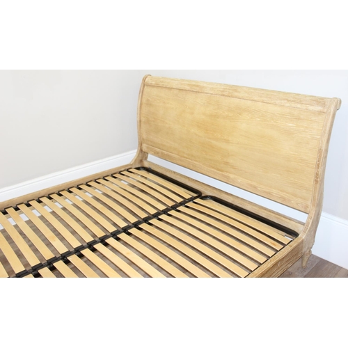 19 - A Loaf Furniture limed oak sleigh formed bed frame, to fit a super king mattress, approx 180cm x 200... 