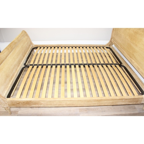 19 - A Loaf Furniture limed oak sleigh formed bed frame, to fit a super king mattress, approx 180cm x 200... 