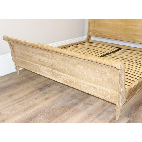 19 - A Loaf Furniture limed oak sleigh formed bed frame, to fit a super king mattress, approx 180cm x 200... 