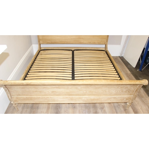 19 - A Loaf Furniture limed oak sleigh formed bed frame, to fit a super king mattress, approx 180cm x 200... 