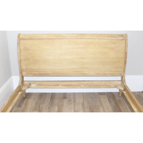 19 - A Loaf Furniture limed oak sleigh formed bed frame, to fit a super king mattress, approx 180cm x 200... 