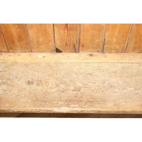 2 - An unusual antique pine pew or bench with high panelled back, one end shaped for corner, likely 19th... 