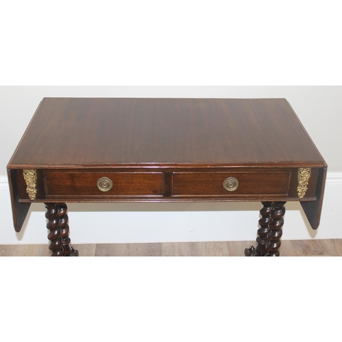 21 - A 19th century mahogany sofa table with barley twist supports and brass handles and accents, approx ... 