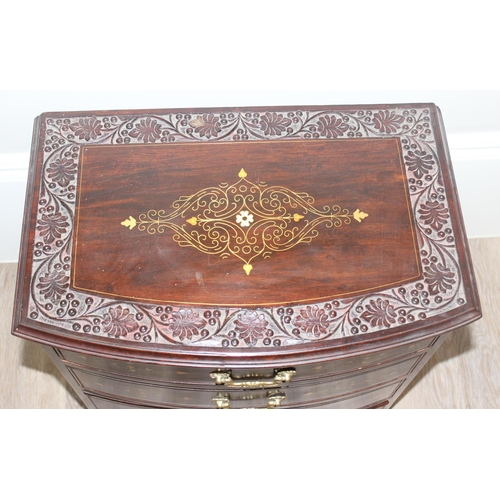 23 - A small vintage Indian style carved 4 drawer chest of drawers with brass inlay and fittings, approx ... 